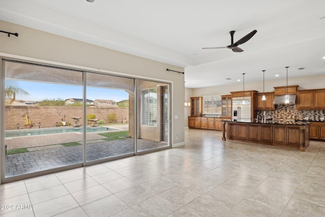 unfurnished living room featuring light tile patterned floors, a wealth of natural light, and ceiling fan