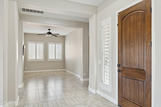 tiled foyer entrance with ceiling fan