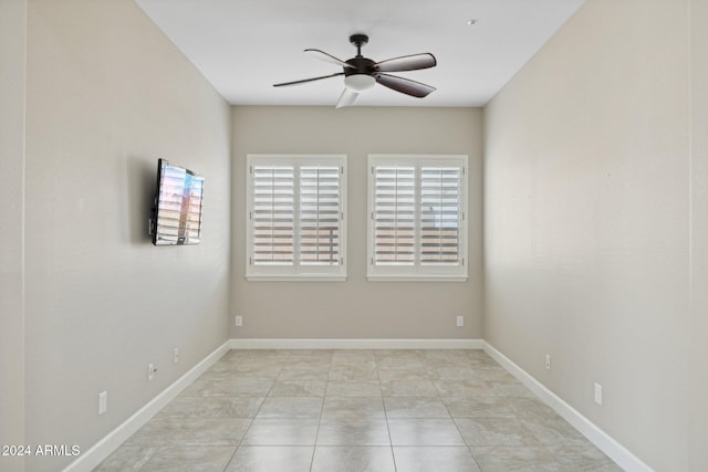 unfurnished room with ceiling fan and light tile patterned flooring