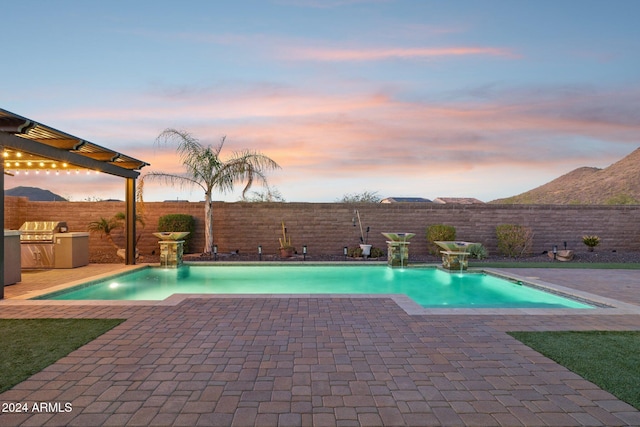 12860 W Calle De Sol, Peoria, AZ 85383 - pool at dusk featuring a fenced backyard and a patio area