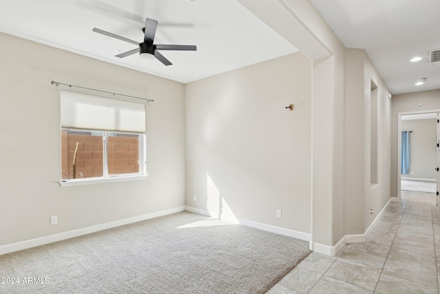 unfurnished room with ceiling fan and light tile patterned floors