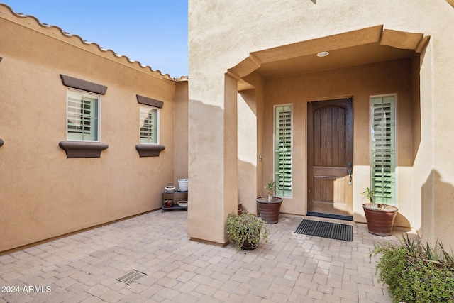 12860 W Calle De Sol, Peoria, AZ 85383 - view of exterior entry featuring stucco siding and a patio area