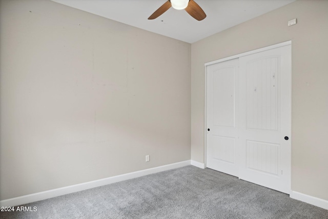 unfurnished bedroom featuring carpet flooring, a closet, and ceiling fan