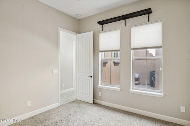 spare room with light colored carpet