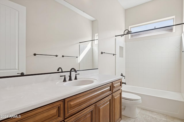 full bathroom with vanity, tile patterned floors, tiled shower / bath combo, and toilet