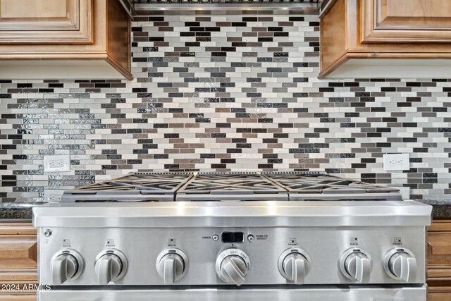 12860 W Calle De Sol, Peoria, AZ 85383 - kitchen view of stove, tasteful backsplash, and brown cabinetry