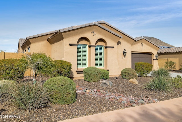 mediterranean / spanish-style home featuring a garage