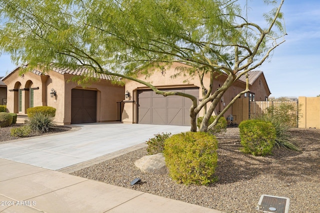 12860 W Calle De Sol, Peoria, AZ 85383 - view of front of home featuring driveway, an attached garage, stucco siding, and a tiled roof
