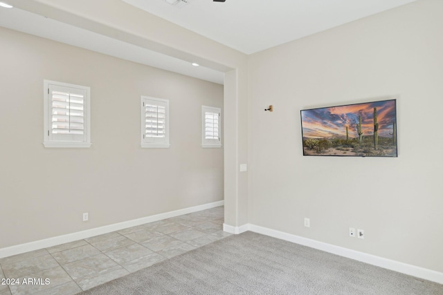 12860 W Calle De Sol, Peoria, AZ 85383 - spare room with baseboards, light tile patterned floors, and light colored carpet