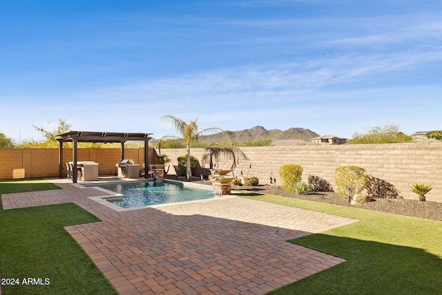 view of pool with a pergola, pool water feature, a patio area, a mountain view, and a lawn