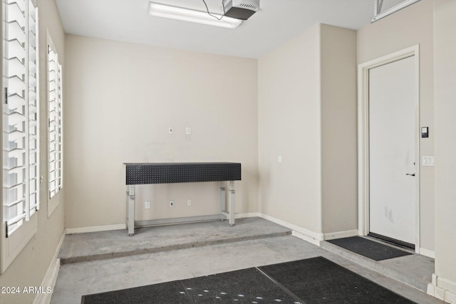 12860 W Calle De Sol, Peoria, AZ 85383 - garage featuring a garage door opener and baseboards