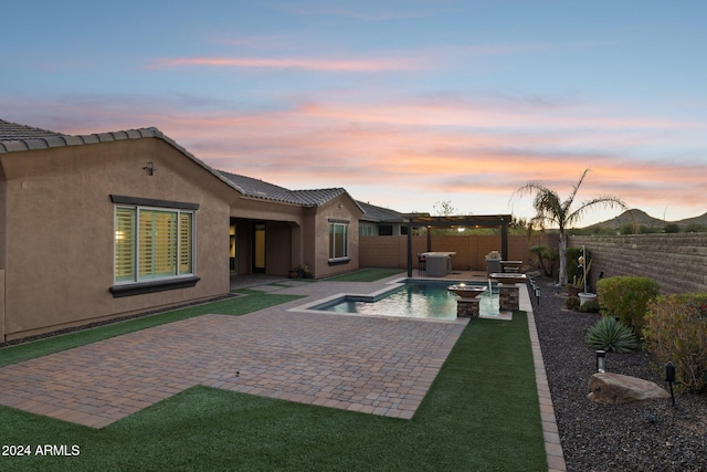 pool at dusk featuring a hot tub, a patio area, and central air condition unit