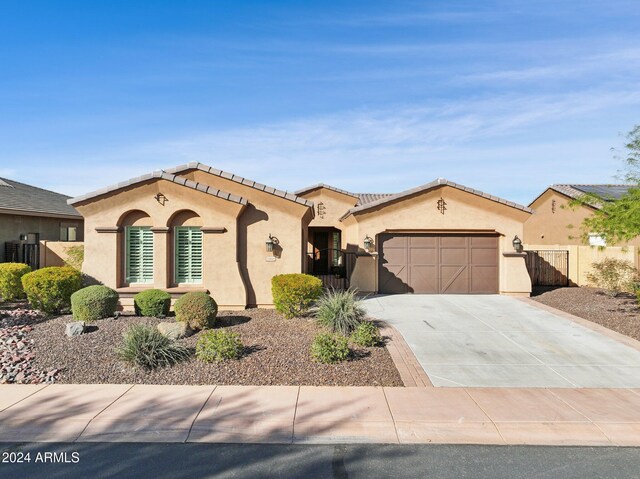 12860 W Calle De Sol, Peoria, AZ 85383 - mediterranean / spanish-style house featuring driveway, a garage, stucco siding, and a tile roof