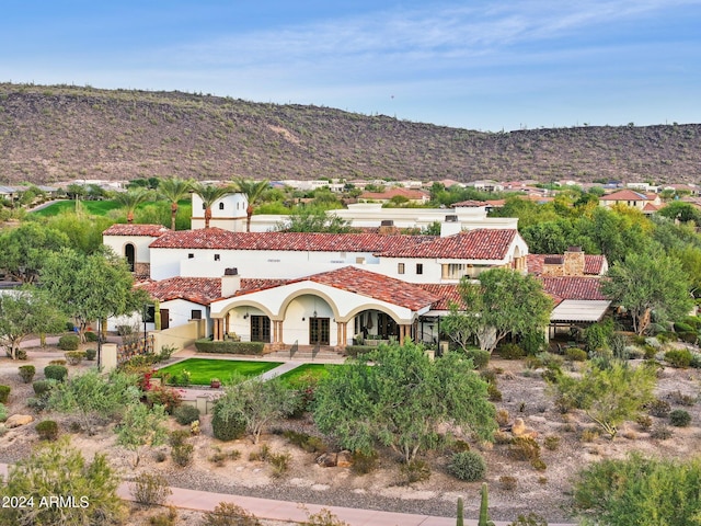 12860 W Calle De Sol, Peoria, AZ 85383 - rear view of property featuring stucco siding, a tiled roof, a mountain view, and a chimney