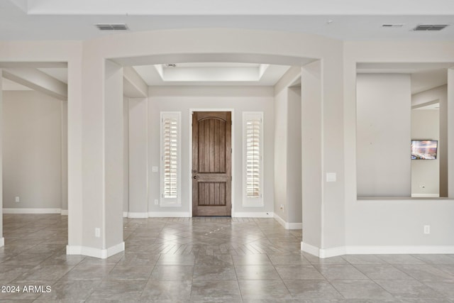 entrance foyer with a tray ceiling