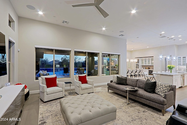 living room with ceiling fan and sink