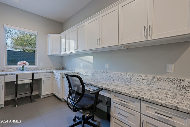 home office featuring light tile patterned floors and built in desk