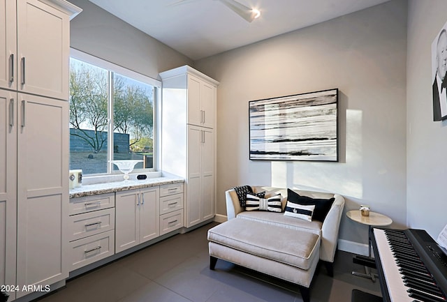 sitting room featuring dark tile patterned flooring