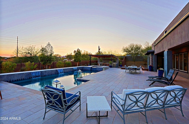 pool at dusk featuring outdoor lounge area and a patio