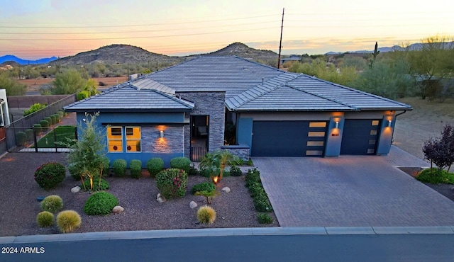 view of front of home featuring a mountain view and a garage