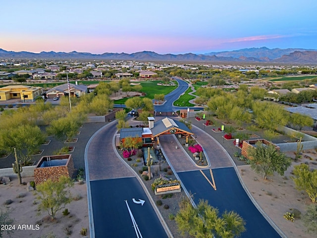 aerial view at dusk featuring a mountain view