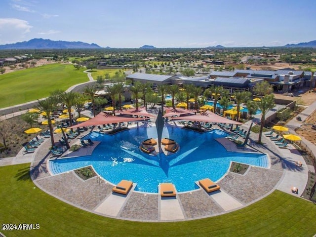 view of pool featuring a mountain view and a yard