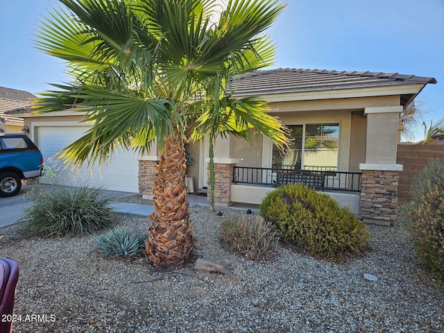 view of front of home with a porch and a garage