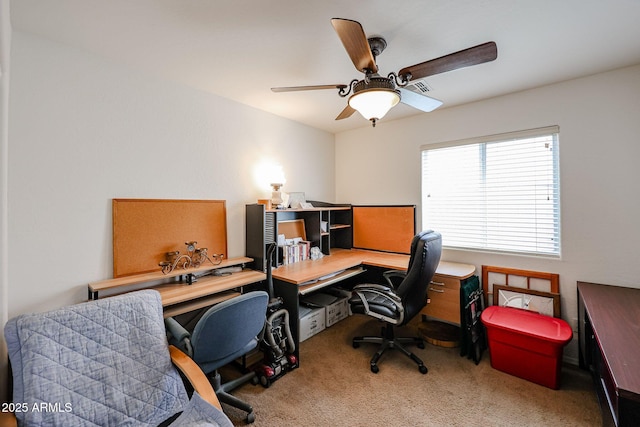 carpeted office featuring ceiling fan