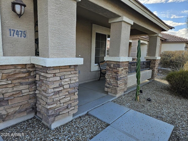 view of exterior entry with covered porch