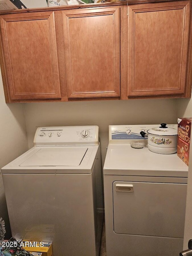 laundry area featuring cabinets and washing machine and clothes dryer