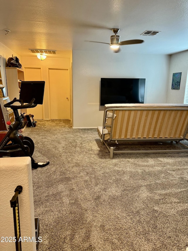 workout area with carpet floors, ceiling fan, and visible vents