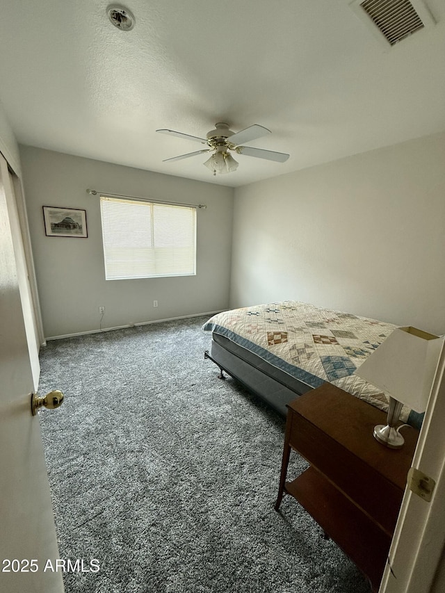 carpeted bedroom featuring ceiling fan, baseboards, and visible vents