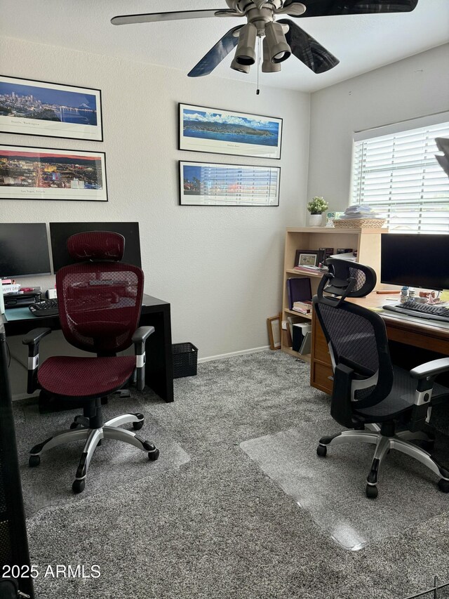 carpeted office with baseboards and ceiling fan