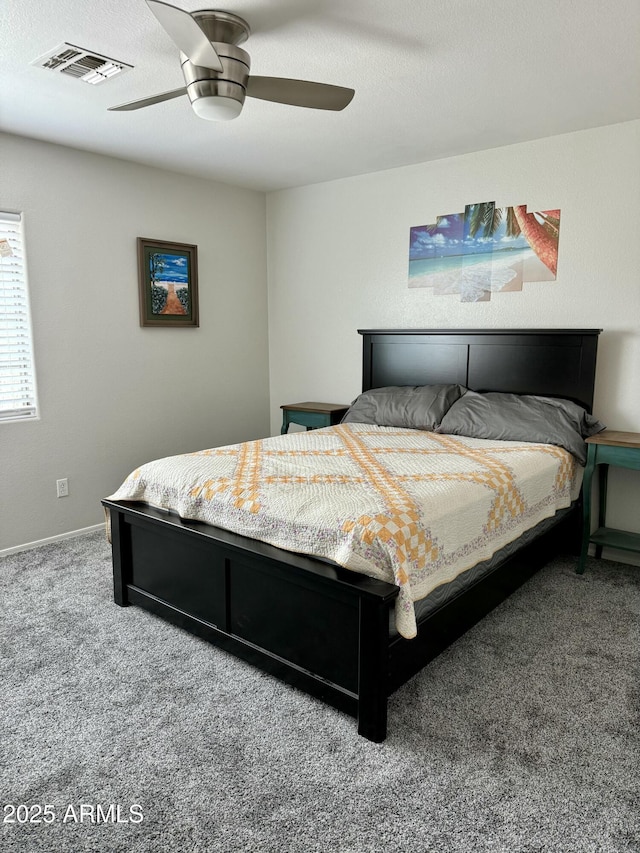 bedroom featuring visible vents, baseboards, a ceiling fan, and carpet