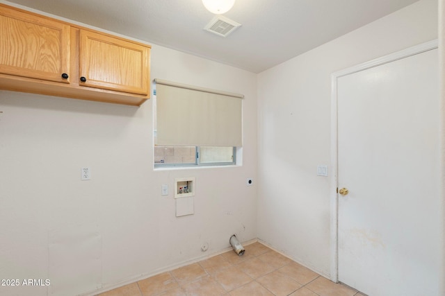 washroom with hookup for an electric dryer, light tile patterned floors, washer hookup, visible vents, and cabinet space