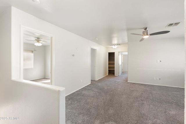spare room with carpet flooring, visible vents, and ceiling fan