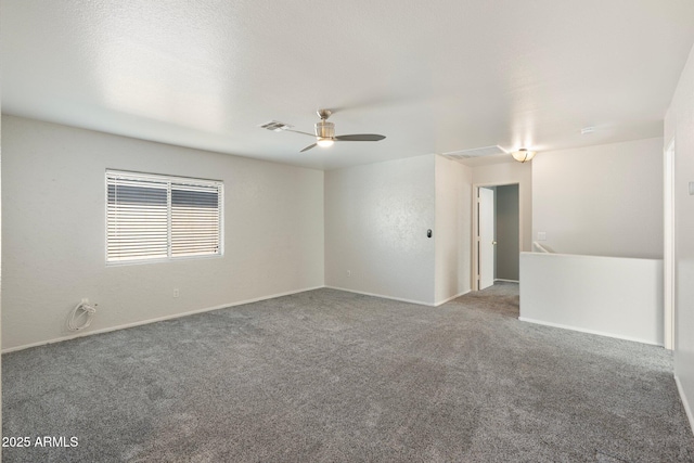 carpeted empty room featuring visible vents, baseboards, and a ceiling fan
