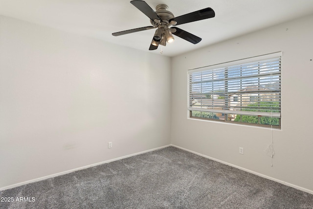 empty room with ceiling fan, carpet flooring, and baseboards
