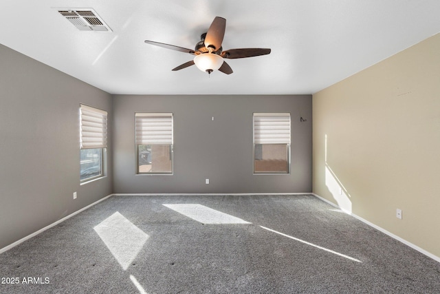 spare room with ceiling fan, baseboards, visible vents, and carpet floors