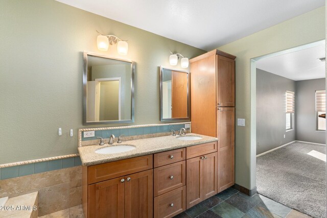 full bath with double vanity and a sink