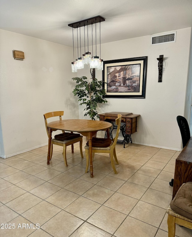 dining room with visible vents, baseboards, and light tile patterned flooring