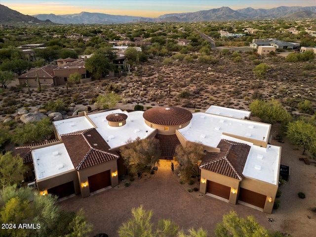 aerial view at dusk featuring a mountain view