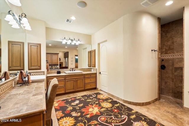 bathroom featuring vanity and tiled shower