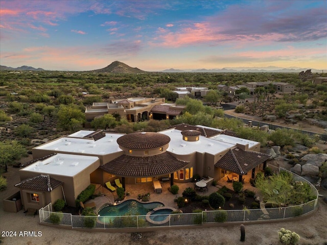 aerial view at dusk featuring a mountain view