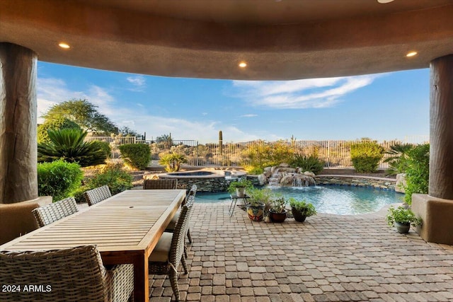 view of patio featuring pool water feature and a swimming pool with hot tub