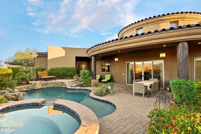 view of pool with a patio, ceiling fan, and an in ground hot tub