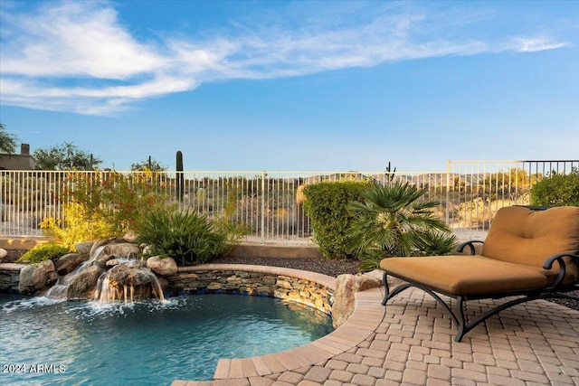 view of pool featuring pool water feature and a patio area