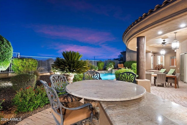 patio terrace at dusk with ceiling fan