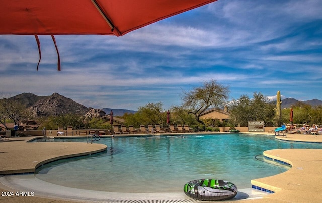 view of pool with a mountain view and a patio