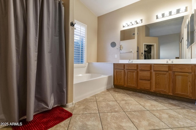 bathroom featuring a washtub, tile patterned flooring, and vanity